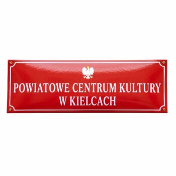 Czerwona urzędowa tablica emaliowana 30x90 cm z godłem państwowym i białym napisem Powiatowe Centrum Kultury w Kielcach.